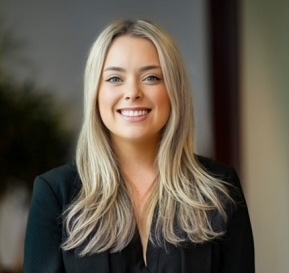 White woman with blonde hair, smiling at camera
