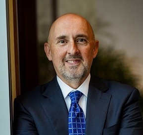 white man smiles at camera