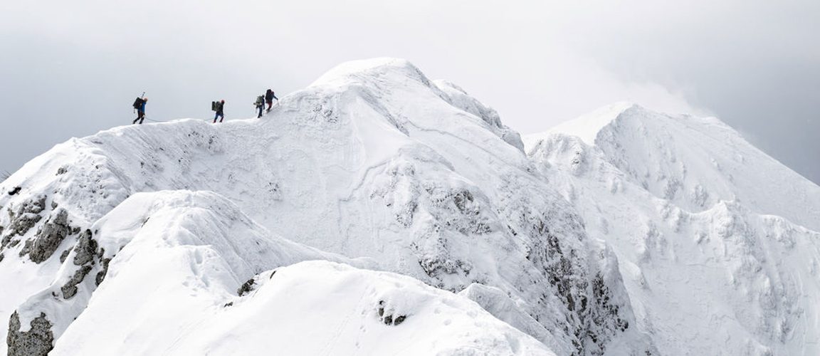 Mountain climbers reaching the summit
