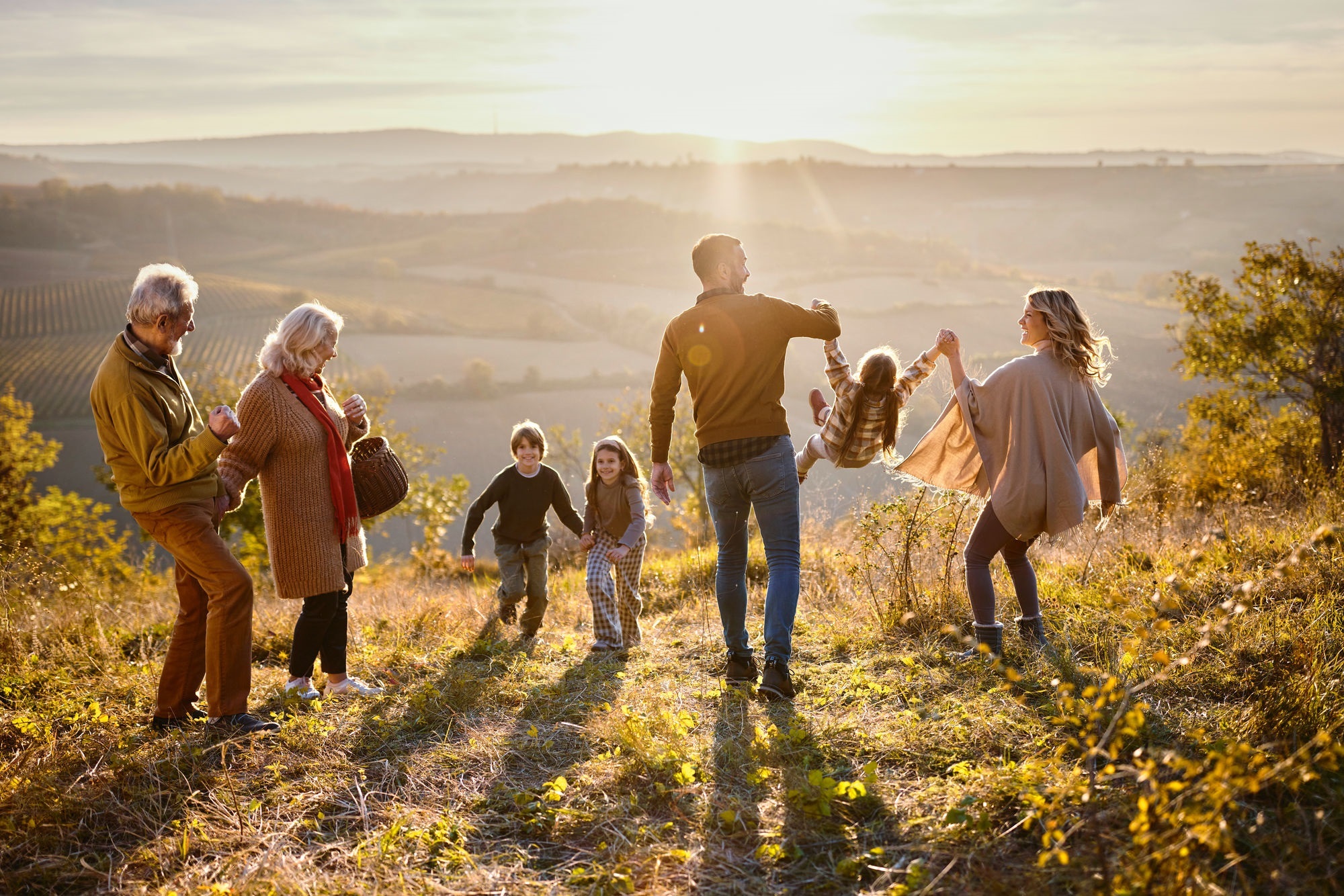family hiking in sunset
