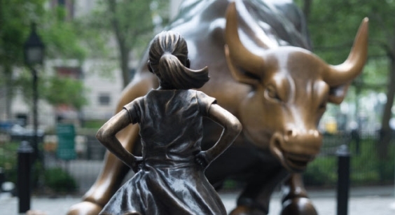 girl staring at bull statue