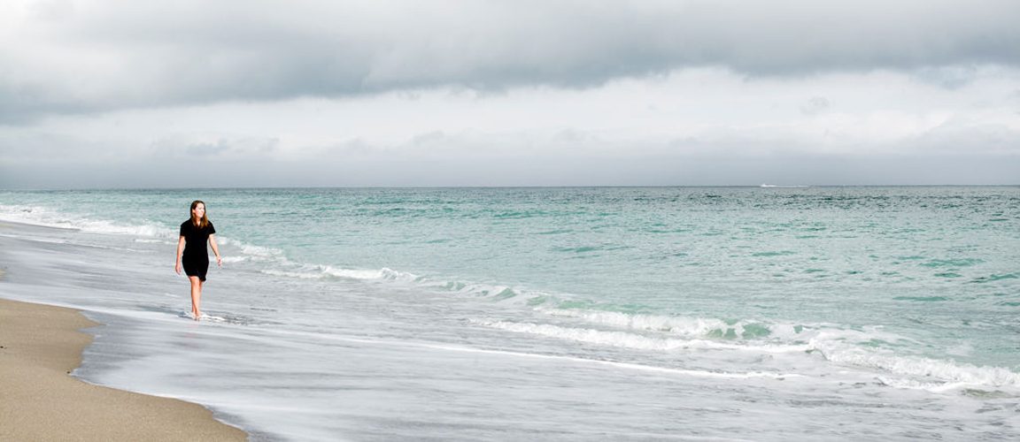 Woman walking along the shoreline