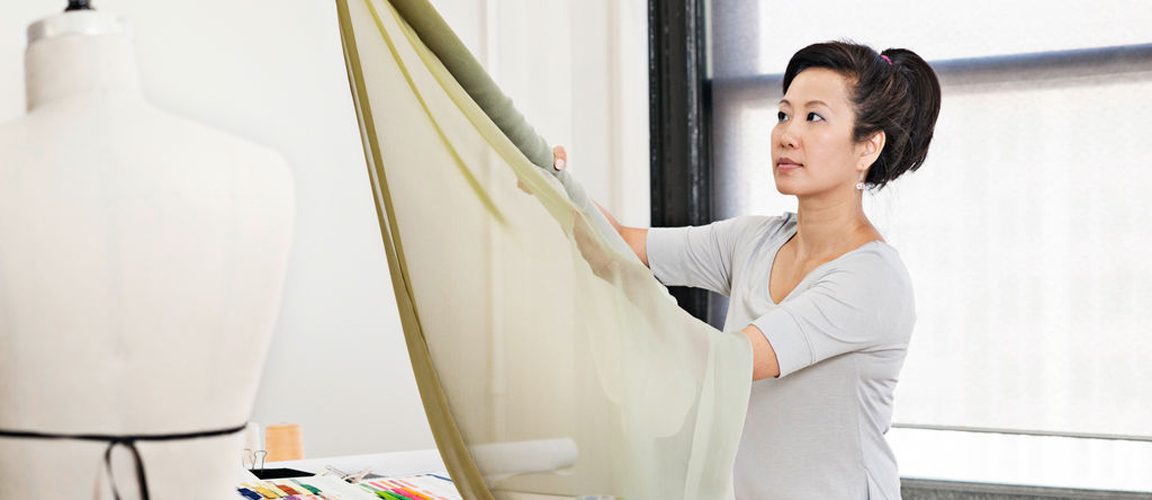 Woman holding fabric in studio