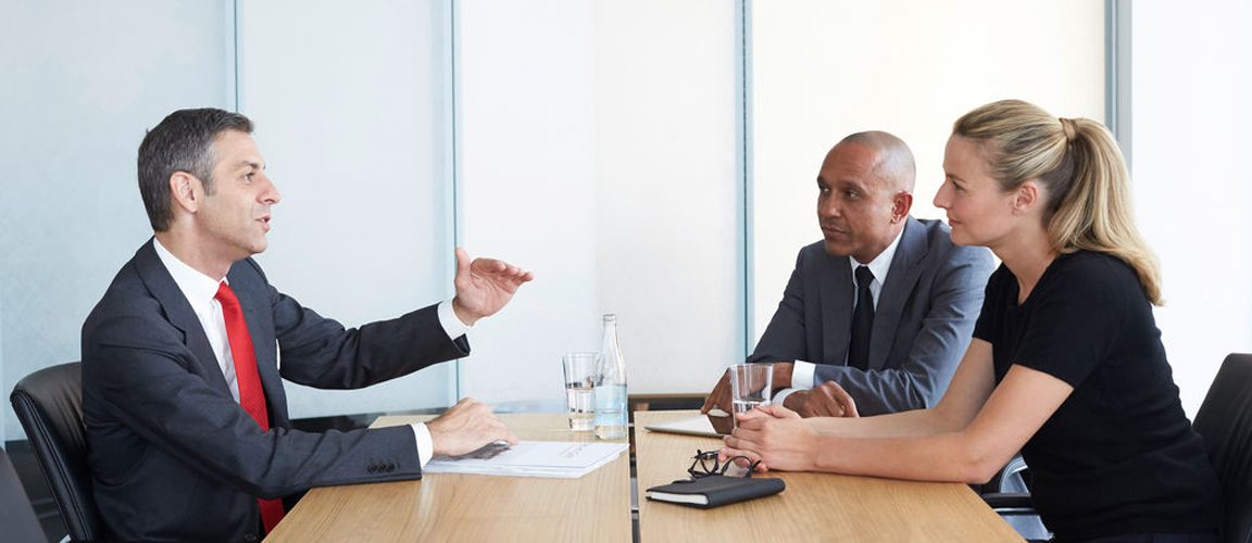 Three business people at a desk